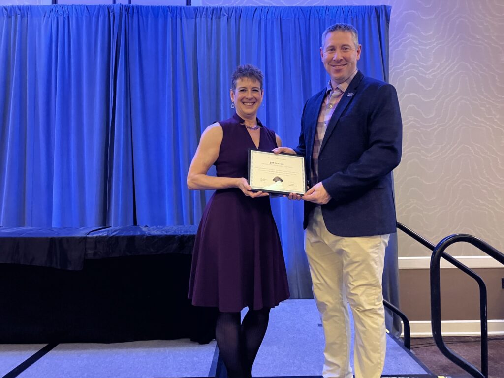 MFA Board Chair Charlene Clark handing a certificate to Jeff Newkirk.