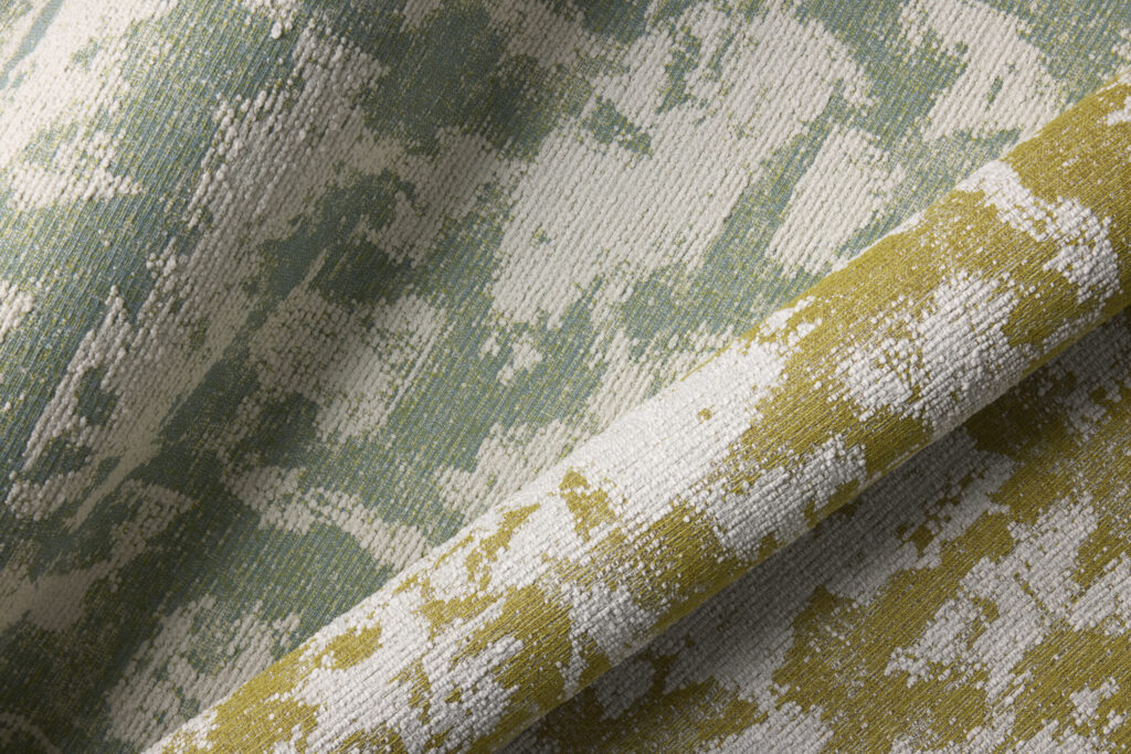 Textured fabric featuring a blend of soft green, white and yellow hues, showcasing a subtle, abstract pattern.