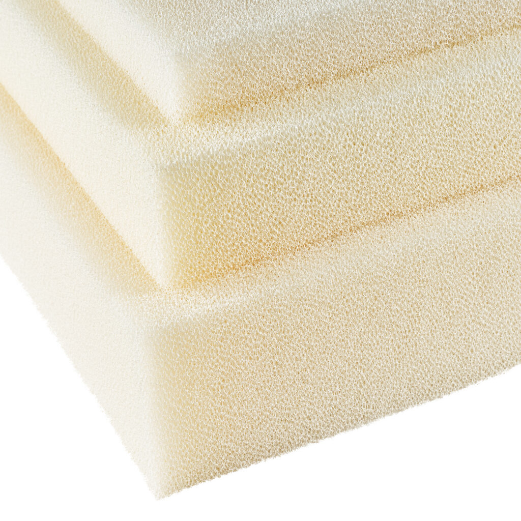 Close-up of three stacked layers of marine-grade foam in a textured, light yellow shade.