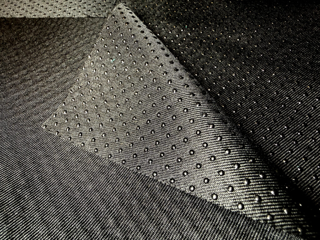 Textured black marine fabric showcasing a woven pattern with raised dots.