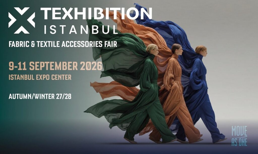 Three models in flowing, colorful fabrics walk together, showcasing textiles. Date and venue details are prominently displayed below.
